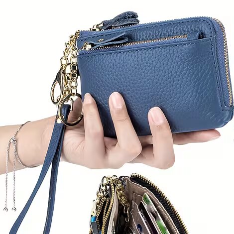Title: Hand holding the navy mini wallet with gold keychain - Description: Hand holding the navy mini wallet with gold keychain